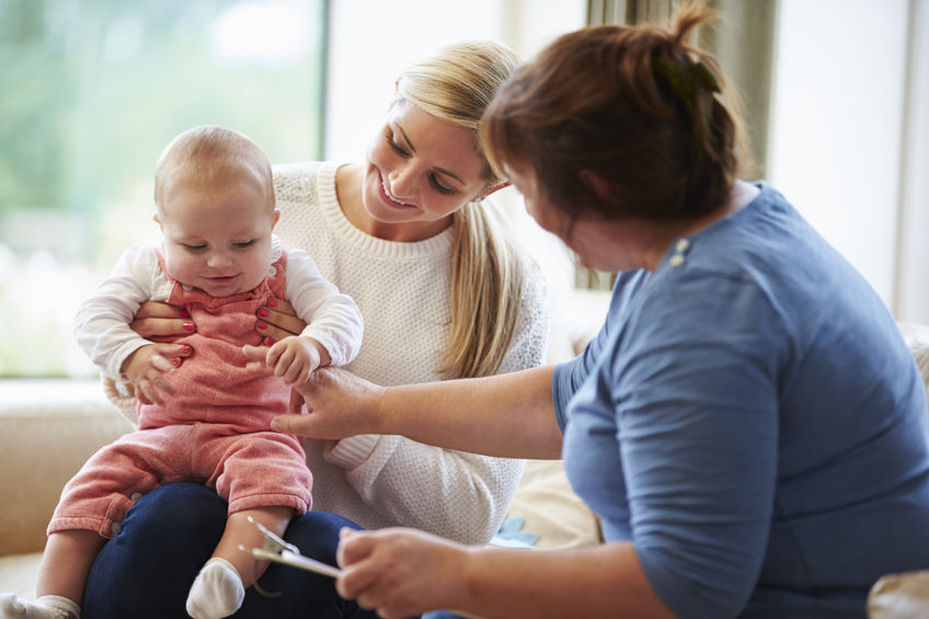 Baby with nurse and parent